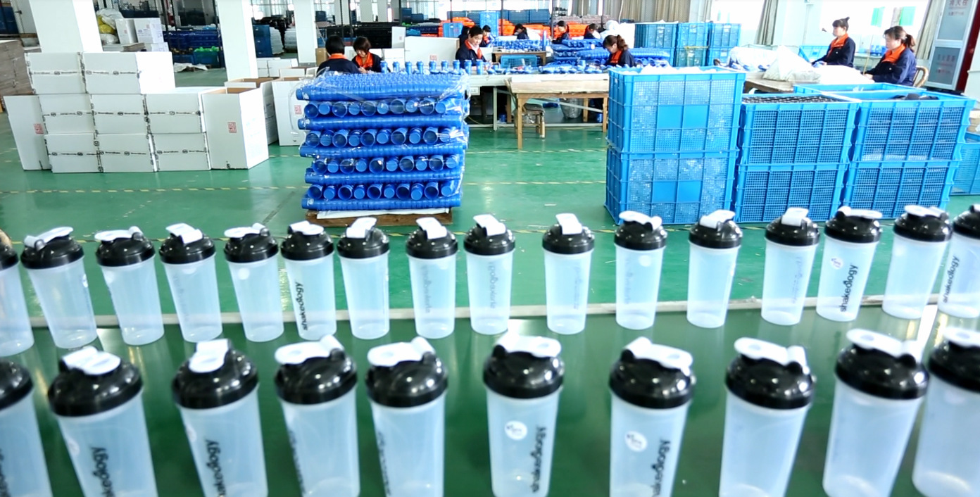 Skilled Workers Pack Shaker Bottles Efficiently